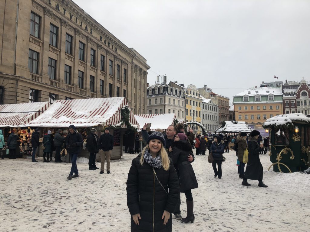 Student stands in middle of busy European market