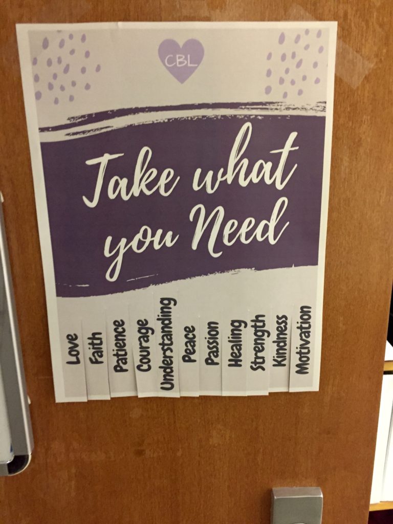 Sheet of paper with "Take what you need" and various words like love, faith, strength on bottom in tearable pieces